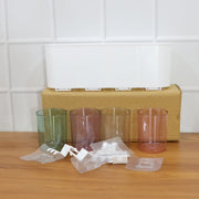 Plastic wall toothbrush rack with four inverted cups and grooming accessory slots
