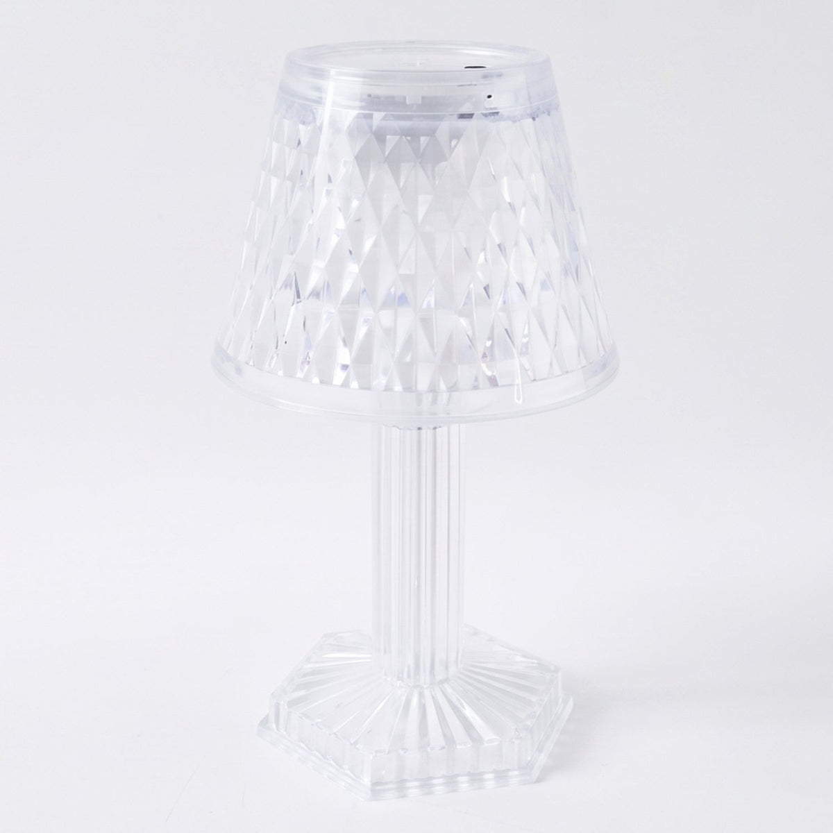 Modern LED crystal lamp displayed on a wooden shelf in a home setting.