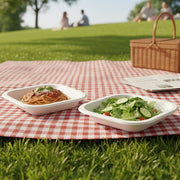 Disposable square food tray set displayed with assorted snacks for serving.