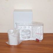 Lifestyle image of wall mounted toothbrush holder with toothbrush and toothpaste inside.