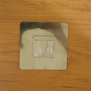 Wall mounted adhesive hook supporting hanging objects