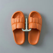 Wall mounted slipper holder in bathroom setting