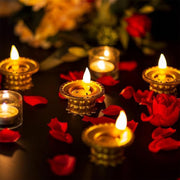 Multiple golden water sensor diyas illuminating a traditional Indian setting.