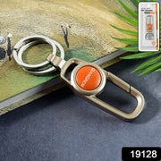Close-up of metal keychain carabiner clip with dual key rings on a white background