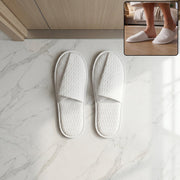 Hotel style white slippers for guest rooms