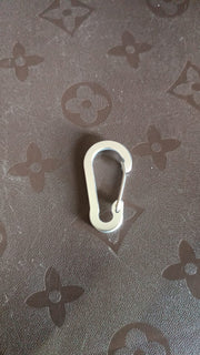 Close-up view of small snap hook clasp showing spring clip