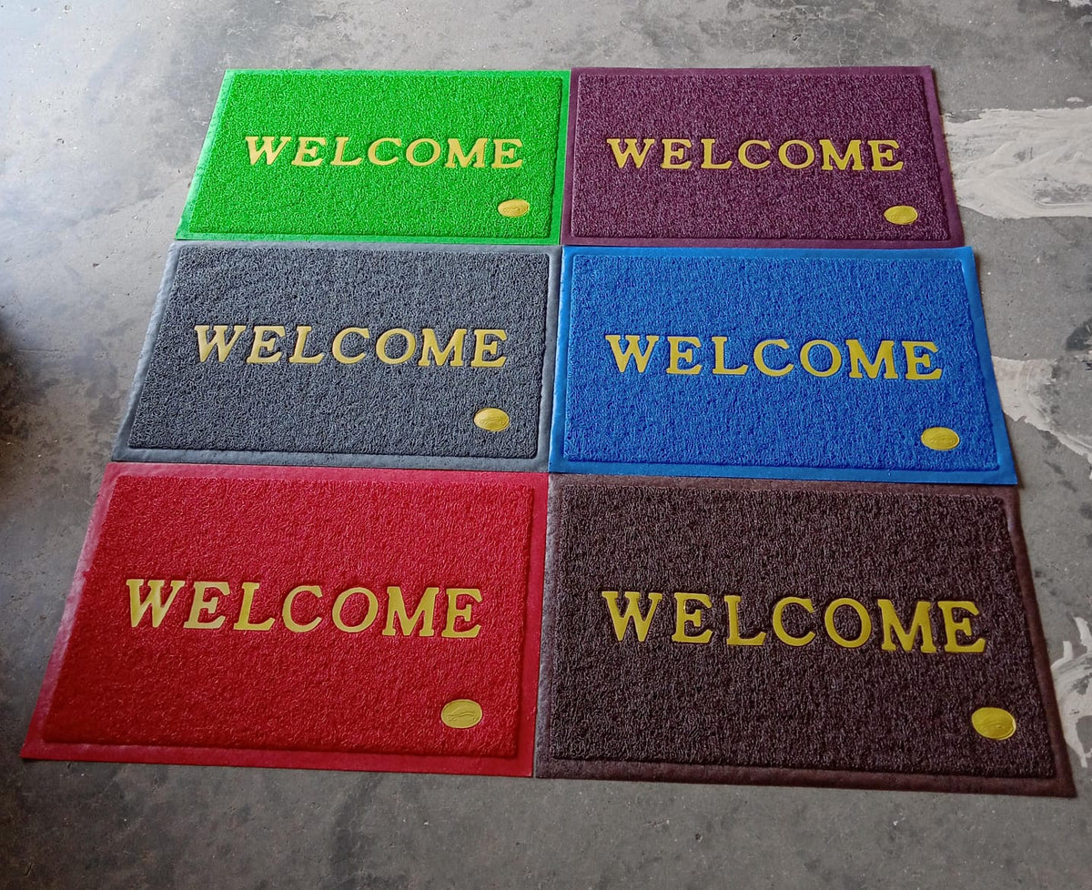 An overhead shot of the Welcome Door Mat in a clean, minimalist home setting.