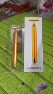 Vibrating facial massage tool in gold finish for skin rejuvenation.