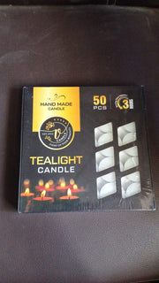 Overhead view of multiple tealight candles in a box.