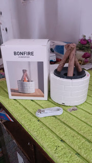 Flame Diffuser creating a warm ambiance on a bedside table with soft lighting.