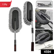 Hand using the soft Car Dust Brush to meticulously clean a car's dashboard without scratching surfaces.
