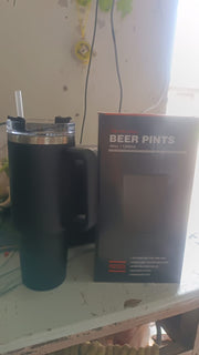 Angled view of stainless steel travel mug with lid and handle visible