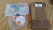 Neatly organized DIY bracelet making kit in a clear storage box