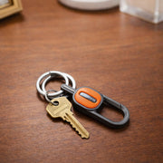 Stylish metal key holder clip attached to belt or backpack