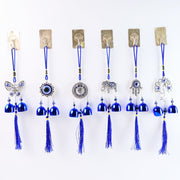 Detailed view of evil eye metal bell wind chime for house protection